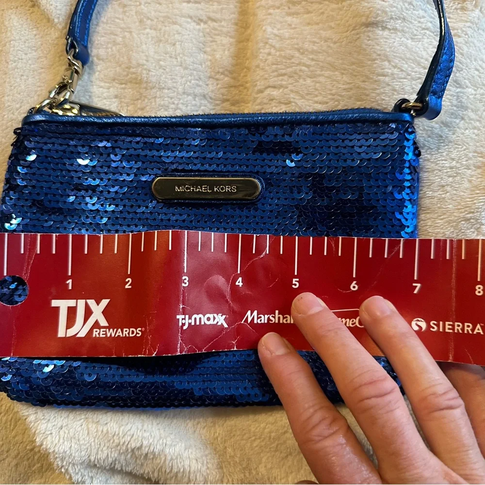 Michael Kors sapphire blue sequined wristlet with gold colored hardware.